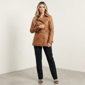 Woman wearing caramel leather trench jacket with belt, double-breasted design and tailored fit, front view