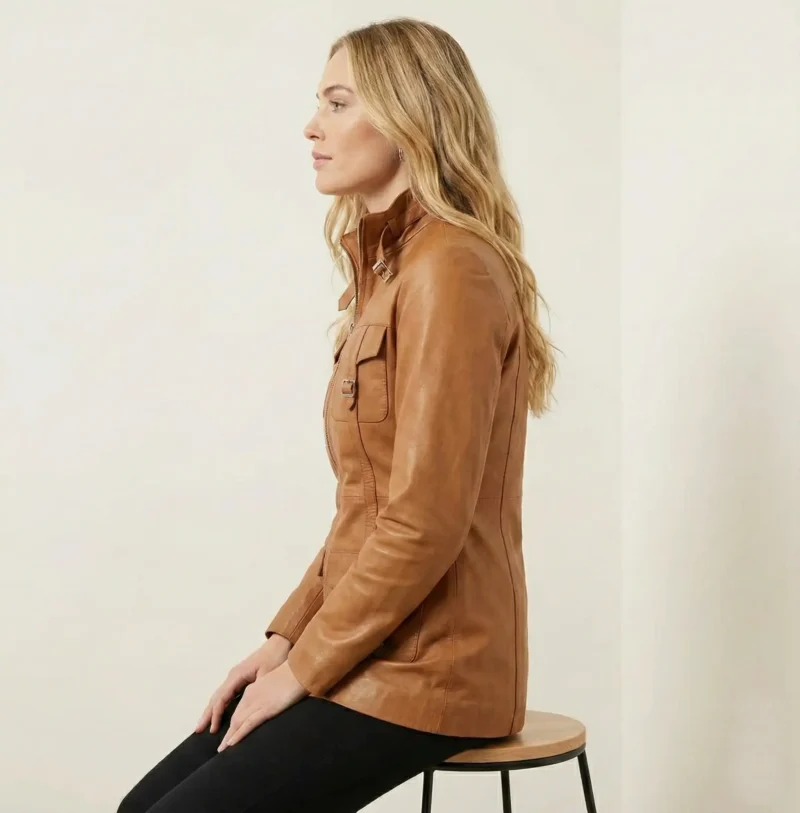 Side view of Crimson Vanguard women’s tan leather coat showing fitted waist and buckle strap details