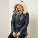 Side view of navy leather parka with fur hood and tailored waist silhouette