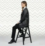 Side view of women’s black leather blazer coat showing fitted waist and mid-thigh length