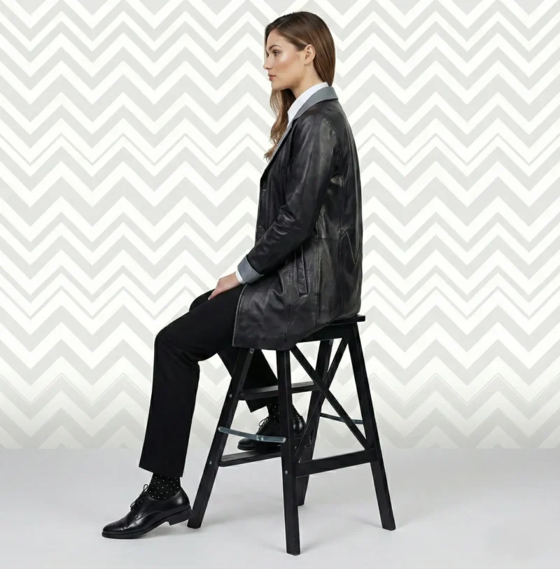 Side view of women’s black leather blazer coat showing fitted waist and mid-thigh length