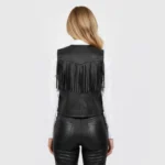 Back view of women’s black leather fringe vest showing smooth leather finish, structured tailoring, and western-inspired design.