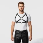 Front view of adjustable black leather chest harness with brass hardware and shoulder straps